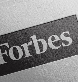 White piece of paper with the Forbes logo printed on it