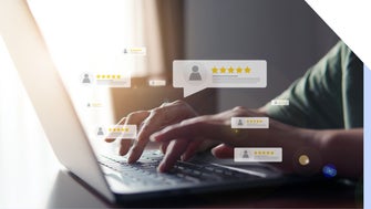 Person typing at a laptop with floating customer reviews around the hand