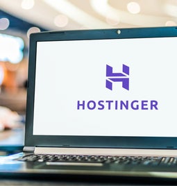 Laptop showing a white screen with Hostinger's logo in the centre