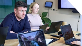 Business colleagues with serious expressions discussing a business matter in an office setting