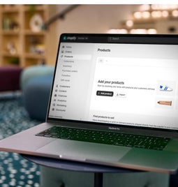 A laptop on a desk displaying an ecommerce platform's product management dashboard, illustrating online store organization.