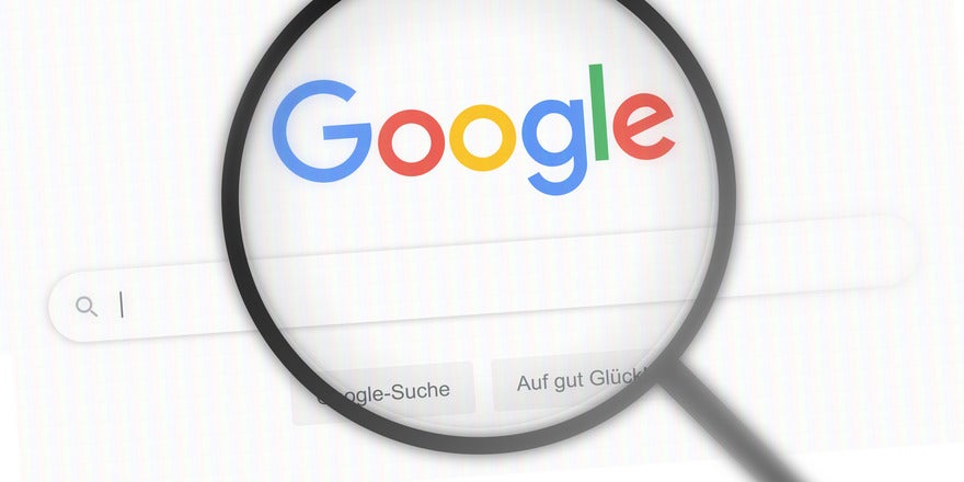 Magnifying glass hovering over the Google homepage