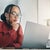 Woman sat and looking focused at the laptop in front of her